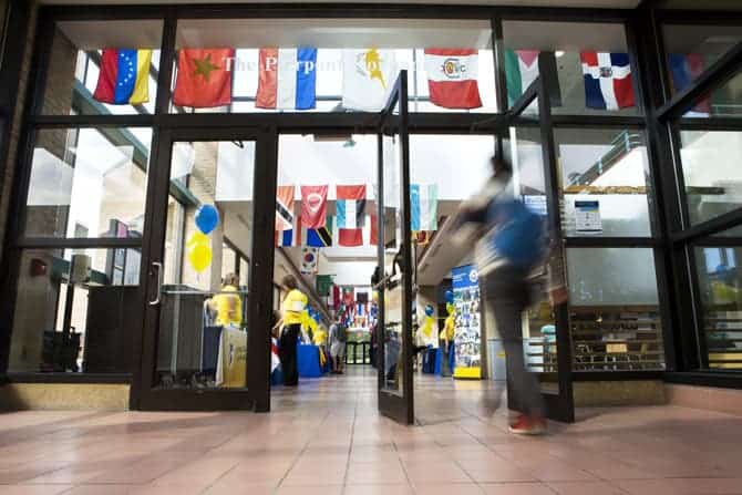 Various national flags hang near the entrance to Pierpont Commons